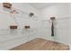 Bright walk-in closet features wire shelving and wood floor at 5312 Allburn Pkwy, Concord, NC 28027