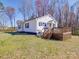 Backyard view with a wooden deck and stairs, complemented by a lush green lawn at 5985 Bertie Ave, Salisbury, NC 28147