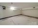 Unfinished basement with white walls and floor, offering potential for customization and storage at 5985 Bertie Ave, Salisbury, NC 28147