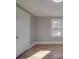 Sun-filled bedroom boasts wood floors, a large window, and ample closet space at 5985 Bertie Ave, Salisbury, NC 28147