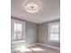 Well-lit bedroom featuring hardwood floors, fresh paint, and two windows at 5985 Bertie Ave, Salisbury, NC 28147