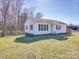 A cozy, well-maintained home with white siding and a spacious yard on a clear, sunny day at 5985 Bertie Ave, Salisbury, NC 28147