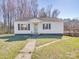 Charming single-story home with a white exterior, black shutters, a well-kept lawn, and a wooden deck at 5985 Bertie Ave, Salisbury, NC 28147