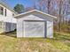 Detached one car garage in the backyard of the property showing a white exterior and a traditional garage door at 5985 Bertie Ave, Salisbury, NC 28147