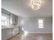 Bright kitchen featuring gray cabinetry, hardwood floors, and natural light from multiple windows at 5985 Bertie Ave, Salisbury, NC 28147