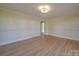 Living room featuring refinished hardwood floors, freshly painted walls, and abundant natural light at 5985 Bertie Ave, Salisbury, NC 28147