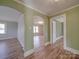 Inviting living room with hardwood floors and arched doorway leading into the room at 5985 Bertie Ave, Salisbury, NC 28147