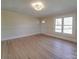 A spacious living room featuring freshly refinished hardwood floors and updated windows at 5985 Bertie Ave, Salisbury, NC 28147