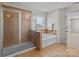Bathroom featuring a glass enclosed shower and a separate soaking tub at 603 Smokehouse Ln, Albemarle, NC 28001