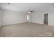 Minimalist bedroom with neutral carpet, ceiling fan, and white walls at 603 Smokehouse Ln, Albemarle, NC 28001