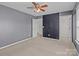 Bedroom featuring neutral carpet, ceiling fan, and attached closet at 603 Smokehouse Ln, Albemarle, NC 28001