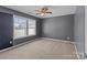 Bedroom features neutral carpet, ceiling fan, and ample natural light at 603 Smokehouse Ln, Albemarle, NC 28001