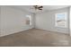 Bedroom features neutral carpet, ceiling fan, and lots of natural light at 603 Smokehouse Ln, Albemarle, NC 28001