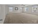 Spacious bedroom with neutral carpet, ceiling fan, and lots of windows at 603 Smokehouse Ln, Albemarle, NC 28001