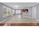 Bright dining area with tiled floors, large windows, and a view into the adjacent kitchen with cherry cabinets at 603 Smokehouse Ln, Albemarle, NC 28001