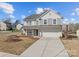Charming two-story home with neutral siding, a covered porch, and a well-maintained front yard at 603 Smokehouse Ln, Albemarle, NC 28001