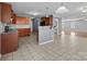 Functional kitchen with dark wood cabinets, tiled flooring, and a breakfast bar, offering ample counter space at 603 Smokehouse Ln, Albemarle, NC 28001
