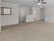 Neutral living room with plush carpet, updated ceiling fan, and ample natural light at 603 Smokehouse Ln, Albemarle, NC 28001