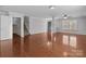 Spacious living room boasts hardwood floors, neutral walls, and a staircase leading to the upper level at 603 Smokehouse Ln, Albemarle, NC 28001