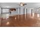 Open-concept living room and kitchen area with hardwood floors transitioning to tiled flooring, great for entertaining at 603 Smokehouse Ln, Albemarle, NC 28001