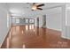 Expansive living room featuring gleaming hardwood floors, neutral walls, and ample space for entertaining at 603 Smokehouse Ln, Albemarle, NC 28001