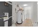 Bright utility room featuring washer, dryer, water heater, and HVAC system, optimizing home maintenance at 603 Smokehouse Ln, Albemarle, NC 28001