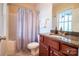 Bathroom featuring a shower-tub combo, granite vanity, and neutral colors at 609 Sunfish Ln, Tega Cay, SC 29708