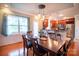 Bright dining room overlooking kitchen featuring hardwood floors, modern light fixtures and neutral paint at 609 Sunfish Ln, Tega Cay, SC 29708