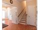 Hallway featuring hardwood floors, staircase, and adjacent rooms at 609 Sunfish Ln, Tega Cay, SC 29708
