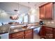 Kitchen featuring stainless steel dishwasher and granite countertops overlooking the dining area at 609 Sunfish Ln, Tega Cay, SC 29708
