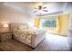 Spacious main bedroom boasting tray ceilings, natural light, and a large window overlooking lush greenery at 609 Sunfish Ln, Tega Cay, SC 29708