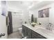 Elegant bathroom with double sinks, gray vanity, and shower-tub combo at 619 R L Stowe Rd, Belmont, NC 28012