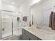 Bathroom featuring glass enclosed shower, gray vanity with white countertop, and modern fixtures at 619 R L Stowe Rd, Belmont, NC 28012