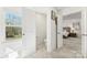 Bright hallway with view to a half-bathroom, a guest room, and backyard views at 619 R L Stowe Rd, Belmont, NC 28012