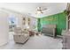 Bright Bedroom featuring a crib, recliner, and green accent wall at 619 R L Stowe Rd, Belmont, NC 28012