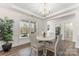 Bright dining room with hardwood floors, elegant chandelier, and natural light at 619 R L Stowe Rd, Belmont, NC 28012