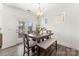 Bright dining area with a wooden table set, a bench, and French doors leading to the patio at 619 R L Stowe Rd, Belmont, NC 28012