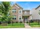 Charming two-story home featuring a brick facade, a black metal fence, and manicured landscaping at 619 R L Stowe Rd, Belmont, NC 28012