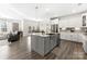 Open kitchen with center island, stainless steel appliances, and hardwood floors at 619 R L Stowe Rd, Belmont, NC 28012