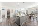 Open kitchen with center island, stainless steel sink, and hardwood floors at 619 R L Stowe Rd, Belmont, NC 28012