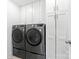 Functional laundry room with modern washer and dryer units, and ample storage cabinets at 619 R L Stowe Rd, Belmont, NC 28012