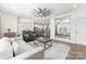 Open concept living room featuring modern ceiling fan, neutral color palette, and view to kitchen at 619 R L Stowe Rd, Belmont, NC 28012