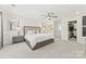 Serene main bedroom boasting neutral colors, a ceiling fan, and decorative bedside tables at 619 R L Stowe Rd, Belmont, NC 28012