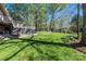 Expansive backyard with lush lawn, mature trees, a deck and a storage shed at 651 25Th Nw Ave, Hickory, NC 28601