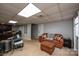 Finished basement featuring a leather couch, drum kit, and neutral carpet at 651 25Th Nw Ave, Hickory, NC 28601