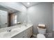 Bathroom with a double sink vanity, mirror and neutral paint at 651 25Th Nw Ave, Hickory, NC 28601
