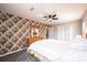 Bedroom with patterned wallpaper, a ceiling fan, and a dresser with mirror at 651 25Th Nw Ave, Hickory, NC 28601