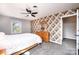 Bedroom with carpet, ceiling fan, floral wallpaper, neutral paint, and an open door at 651 25Th Nw Ave, Hickory, NC 28601
