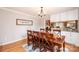 Dining room with hardwood floors and a wooden table next to a kitchen area at 651 25Th Nw Ave, Hickory, NC 28601