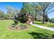 Exterior view with a lush lawn, mature trees, and long driveway at 651 25Th Nw Ave, Hickory, NC 28601